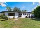 A well-maintained backyard features a patio area with outdoor seating, perfect for relaxing or entertaining guests at 3204 Tradewinds Trl, Orlando, FL 32805