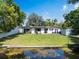 A spacious backyard offers a serene waterfront view, providing a peaceful retreat from the hustle and bustle at 3204 Tradewinds Trl, Orlando, FL 32805