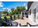 Charming backyard featuring a tiled patio with outdoor seating, ideal for enjoying the tranquil waterfront view at 3204 Tradewinds Trl, Orlando, FL 32805