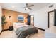 Bedroom featuring a ceiling fan, wood accent wall, and access to an en suite bathroom at 3204 Tradewinds Trl, Orlando, FL 32805