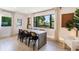 Elegant dining room with a large table and chairs, enhanced by natural light streaming through the expansive window at 3204 Tradewinds Trl, Orlando, FL 32805