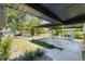 A well-manicured home entrance featuring modern landscaping and covered parking at 3204 Tradewinds Trl, Orlando, FL 32805