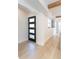 Inviting entryway featuring wood-look floors and a stylish modern door with glass inserts at 3204 Tradewinds Trl, Orlando, FL 32805