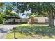 Charming single-story home with a covered carport, modern siding, and a green lawn at 3204 Tradewinds Trl, Orlando, FL 32805
