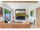 Cozy living room with modern decor and a large window overlooking the lush backyard at 3204 Tradewinds Trl, Orlando, FL 32805