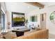 Spacious living room featuring modern decor, a large media center, and access to outdoor views at 3204 Tradewinds Trl, Orlando, FL 32805