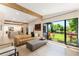Open-concept living space with modern furniture, a large window, and a seamless transition to the outdoor greenery at 3204 Tradewinds Trl, Orlando, FL 32805