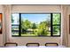 Scenic view from the dining area overlooking lush greenery and a tranquil pond at 3204 Tradewinds Trl, Orlando, FL 32805