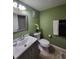 Bathroom with a vanity, toilet, decorative mirror, and fresh towels at 325 N Causeway # D104, New Smyrna Beach, FL 32169