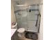 Modern bathroom featuring tile shower, glass door, and dark gray floor mat at 325 N Causeway # D104, New Smyrna Beach, FL 32169