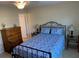 Bedroom features queen bed, two side tables and bright natural light from the window at 325 N Causeway # D104, New Smyrna Beach, FL 32169