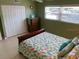 Comfortable bedroom features double closets, and bright natural light from the window at 325 N Causeway # D104, New Smyrna Beach, FL 32169