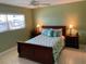 Cozy bedroom featuring a queen bed, ceiling fan, and bright natural light at 325 N Causeway # D104, New Smyrna Beach, FL 32169