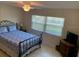 Bedroom featuring queen bed and bright natural light from the window at 325 N Causeway # D104, New Smyrna Beach, FL 32169