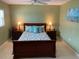 Inviting bedroom with queen bed, neutral walls and bright natural light from window at 325 N Causeway # D104, New Smyrna Beach, FL 32169
