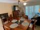 Inviting dining room with a wooden table, decorative centerpiece, and views of the living area at 325 N Causeway # D104, New Smyrna Beach, FL 32169