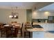 Bright kitchen with white cabinets, sleek appliances, breakfast bar, adjacent to the dining area at 325 N Causeway # D104, New Smyrna Beach, FL 32169