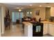 Open kitchen with white cabinets, black appliances, granite countertops, and an adjacent dining area at 325 N Causeway # D104, New Smyrna Beach, FL 32169