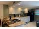 Well-lit kitchen with white cabinetry, sleek appliances, and a breakfast bar for casual dining at 325 N Causeway # D104, New Smyrna Beach, FL 32169
