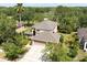 Aerial view of home showcasing roof, three-car garage and surrounding trees at 341 Kirkhill St, Ocoee, FL 34761
