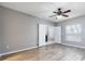Bright bedroom featuring modern wood-look flooring, large windows, and a ceiling fan at 341 Kirkhill St, Ocoee, FL 34761