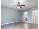 Spacious bedroom featuring wood-look flooring, a ceiling fan, and a view into the en-suite bathroom at 341 Kirkhill St, Ocoee, FL 34761