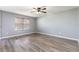 Comfortable bedroom featuring sleek wood-look floors and a modern ceiling fan at 341 Kirkhill St, Ocoee, FL 34761