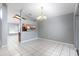 Bright dining room with tile floors, chandelier and seamless access to the kitchen at 341 Kirkhill St, Ocoee, FL 34761