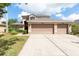 Charming two-story home with a three car garage and a well maintained front yard at 341 Kirkhill St, Ocoee, FL 34761