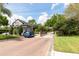 Neighborhood guard house with brick-paved roads, manicured greenery, and a beautiful blue sky at 341 Kirkhill St, Ocoee, FL 34761
