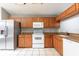 Kitchen featuring stainless steel appliances, oak cabinets, granite countertops, and tile flooring at 341 Kirkhill St, Ocoee, FL 34761