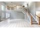 Spacious living room featuring high ceilings, a staircase to the second floor, and tile flooring at 341 Kirkhill St, Ocoee, FL 34761