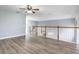 Open loft area with wood-look floors and a staircase to a lower level at 341 Kirkhill St, Ocoee, FL 34761