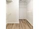 A walk-in closet with wood-look floors and wire shelving, ready for organizing your wardrobe at 341 Kirkhill St, Ocoee, FL 34761