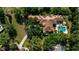 Expansive aerial view of the property showcasing the layout, lush landscaping, pool, and architectural details at 3412 Lilas Ct, Windermere, FL 34786