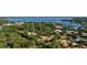 Panoramic aerial view of the property highlighting the estate and beautiful water views beyond the lush landscaping at 3412 Lilas Ct, Windermere, FL 34786