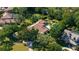 Estate aerial view featuring the pool, terracotta roof, verdant landscaping, and circular driveway at 3412 Lilas Ct, Windermere, FL 34786