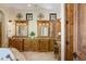 Elegant bathroom with dual vanities, granite countertops, and decorative mirrors at 3412 Lilas Ct, Windermere, FL 34786