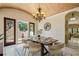 Sunlit dining area with outdoor views, chandelier, and stylish furnishings at 3412 Lilas Ct, Windermere, FL 34786