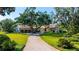 Elegant estate with a brick driveway, three car garage, beautiful lawn, and lush landscaping at 3412 Lilas Ct, Windermere, FL 34786