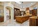 Spacious kitchen with custom wood cabinets, stone counters, stainless appliances, and designer touches at 3412 Lilas Ct, Windermere, FL 34786