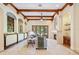 Bright living room featuring beamed ceilings, stone fireplace, travertine floors, and french doors to the backyard at 3412 Lilas Ct, Windermere, FL 34786