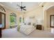 Bright bedroom features large windows, sitting area, and tray ceiling at 3412 Lilas Ct, Windermere, FL 34786