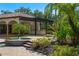 Outdoor kitchen with a fireplace and beamed pergola, creating a perfect space for entertaining and enjoying the outdoors at 3412 Lilas Ct, Windermere, FL 34786