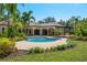 The covered lanai overlooks the pool, a spa, and lush landscaping, making it a perfect outdoor retreat at 3412 Lilas Ct, Windermere, FL 34786