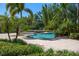 The pool features a raised spa, and a lushly landscaped backyard, offering a private oasis at 3412 Lilas Ct, Windermere, FL 34786
