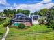 Stunning aerial view of a modern home featuring a screened pool, lush landscaping, and fenced yard at 4301 Down Point Ln, Windermere, FL 34786