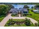 A beautiful home with lush landscaping, a circular driveway, and an amazing waterfront view at 4301 Down Point Ln, Windermere, FL 34786