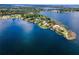 Waterfront home nestled on a peninsula, surrounded by lush greenery and panoramic lake views at 4301 Down Point Ln, Windermere, FL 34786