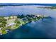Stunning aerial view of waterfront homes on a peninsula with docks and lush landscaping at 4301 Down Point Ln, Windermere, FL 34786